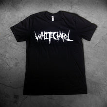 Load image into Gallery viewer, image of a black tee shirt laid flat on a concrete floor. tee has center chest print in white that says whitechapel
