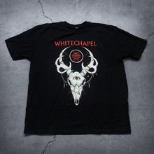 Load image into Gallery viewer, Image of a black tshirt against a grey concrete background. Across the center of the shirt in red text reads &quot;whitechapel&quot;. Below this is a graphic of a deer skull with antlers. The deer has a third eye in the center of its head. The eye is red. The center of the antlers has a white outlined circle with no fill. inside the circle are two red stars mirroring each other. 
