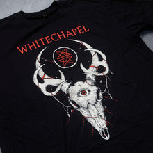 Load image into Gallery viewer, close up Image of a black tshirt against a grey concrete background. Across the center of the shirt in red text reads &quot;whitechapel&quot;. Below this is a graphic of a deer skull with antlers. The deer has a third eye in the center of its head. The eye is red. The center of the antlers has a white outlined circle with no fill. inside the circle are two red stars mirroring each other. 
