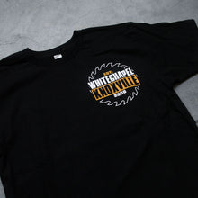 Load image into Gallery viewer, close up Image of a black tshirt against a grey concrete background. The left chest features the outline of a white sawblade. In the center of it in yellow, white, and black text reads &quot;est. 2006, whitechapel, knoxville&quot;. The words whitechapel and knoxville are larger than the est 2006. 
