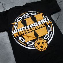 Load image into Gallery viewer, close up Image of the back of a black tshirt against a grey concrete background. There is a large yellow W in the center of the shirt, and the word &quot;whitechapel&quot; is written across it in a white to yellow gradient. surrounding this is a white chain, and the words knoxville repeatedly in alternating yellow and white colors. There is a yellow sawblade with three black stars in the center of the sawblade just under the large W.
