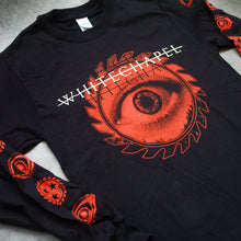 Load image into Gallery viewer, close up Image of the front of a black long sleeve shirt against a grey concrete background. Across the center of the shirt in white text with a white line through it reads &quot;whitechapel&quot;. there is a black shadow of this writing below it. The center of the shirt has a red sawblade with an open eye on it. The sleeves feature alternating symbols descending down the sleeves- an eye symbol and a sawblade with three black stars in the center of the sawblade. These are in red also.
