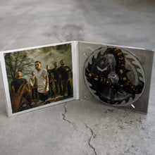 Load image into Gallery viewer, image of the inside of an opened gatefold CD on a concrete floor. The inside left is a photo of the six male members of the band, Whitechapel standing outside in front of a tree, the right shows the CD with a sawblade and snake on the CD
