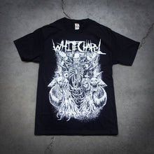 Load image into Gallery viewer, image of a black tee shirt laid flat on a cracked concrete floor. tee has full body print in white of a skeleton devil holding an hourglass and has several demons surronding it. at the top says whitechapel.
