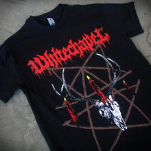 Load image into Gallery viewer, close up, angled image of a black tee shirt laid flat on a concrete floor. front of tee has full body print. at the top in red says whitechapel. below is a deer skull with a burning candle and a pentagram made out of sticks.
