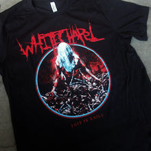 Load image into Gallery viewer, close up, angled image of a black tee shirt laid flat on a concrete floor. tee has center chest print. at the top in red says whitechapel. below is a circle, with an image of a man with a sheet over his head wrapped in barbed wire. at the bottom says this is exile.
