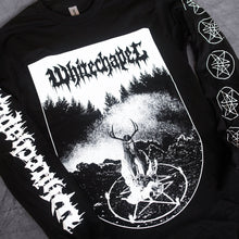 Load image into Gallery viewer, close up image of a black long sleeve tee shirt laid on a concrete floor. front of shirt has full body print in white that says whitechapel at the top over a scene of a ritual in the woods with a pentagram. left sleeve says whitechapel and right sleeve has five pentagrams
