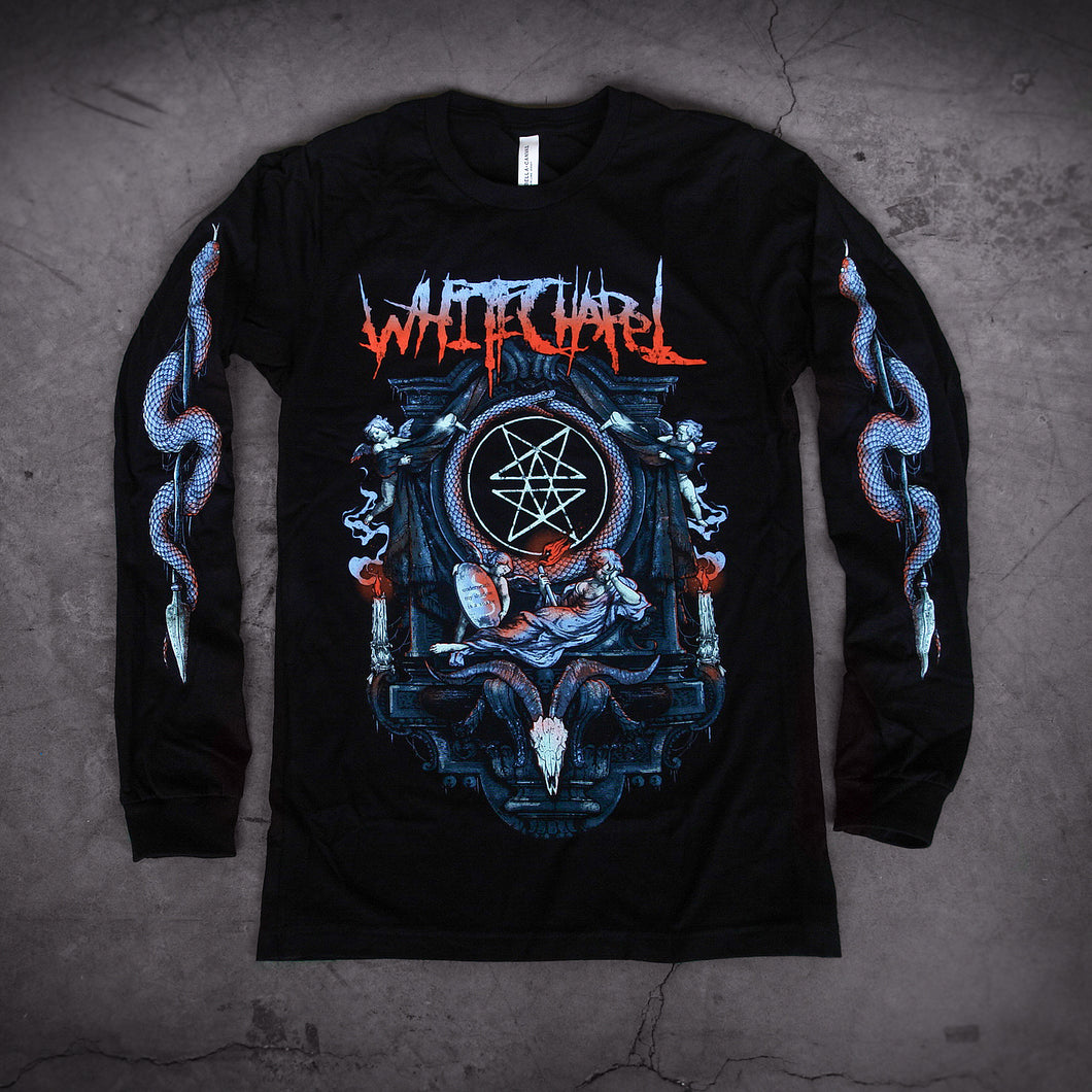 image of a black long sleeve tee shirt laid on a concrete. tee has full body print of an altar with an angel laying across, above a serpent head. at the top says whitechapel. each sleeve has a print of a serpentine wrapped around an arrow