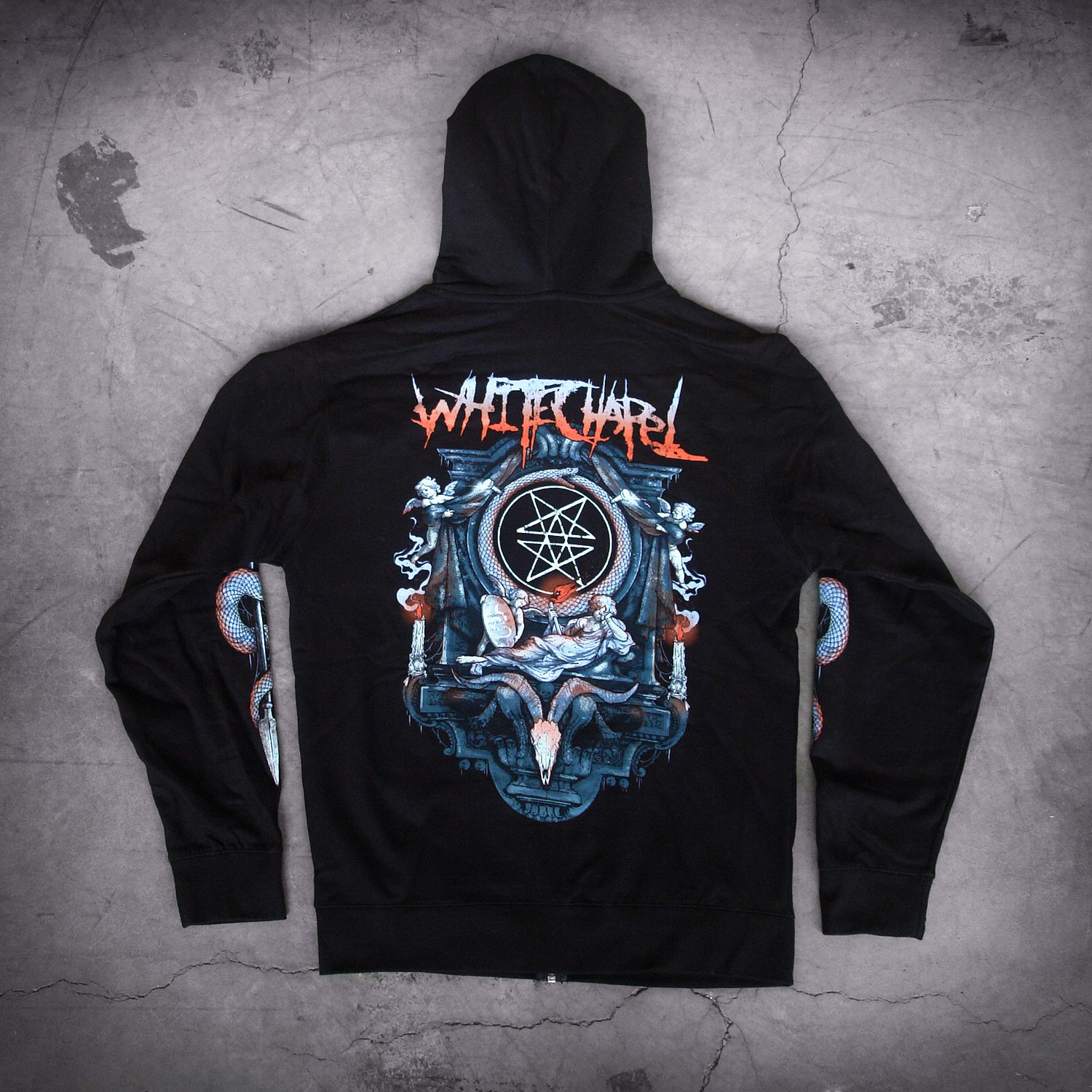 image of the back of a black zip up hoodie laid on a concrete floor. full back print of an altar with a woman laying in front of a goat skull. at the top across the shoulders says whitechapel.