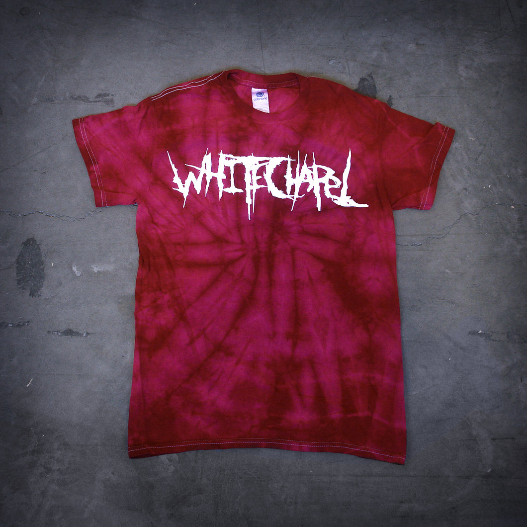 image of a crimson red spider tie dye tee shirt. tee has front center chest print across in white that says Whitechapel