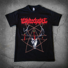 Load image into Gallery viewer, image of a black tee shirt laid flat on a concrete floor. front of tee has full body print. at the top in red says whitechapel. below is a deer skull with a burning candle and a pentagram made out of sticks.
