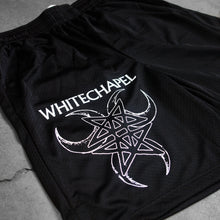 Load image into Gallery viewer, close up Image of black athletic shorts against a grey concrete background. The right bottom of the leg of the shorts says &quot;whitechapel&quot; across the leg in white text. Below that is a graphic of three cresent moons outlined in white- one facing the left, one the right, and one straight down. In the center of that is a double pentagram- two stars mirroring and slightly overlapping each other, also in white. 
