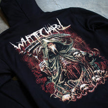 Load image into Gallery viewer, up close Image of the back of a black hooded sweatshirt against a grey concrete background. the back features a red, white, black, and bluish gray graphic of a an animal skull with a third eye holding a scythe and wearing a cloak. Its ribs are showing. There are skull heads all around the monster. There is a red background behind the graphic.
