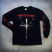 Load image into Gallery viewer, Image of a black longsleeve against a grey concrete background. Across the chest in red text reads &quot;whitechapel&quot;. Below that is a graphic of a white crosswith antlers on it, and an animal skull in the center of the cross. The sleeves feature a graphic of a red outline circle with no fill, with two red stars mirroring each other on the inside of it. This appears on the sleeves repeatedly from the top to the bottom of them.
