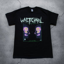 Load image into Gallery viewer, Image of a black tshirt against a grey concrete background. Across the chest of the shirt in white heavy metal font reads &quot;whitechapel&quot;. Below this there is a green outline of a square. The inside of the square features a graphic of the side profiles of two faces. They have pink, yellow, and blue splotches on their heads and noses. There is a small white sawblade with three stars in the center of it on the right side of the shirt. 
