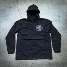 Load image into Gallery viewer, Image of the front of a black pullover windbreaker against a grey concrete background. The left chest has what is called a double pentagram, it is a white circle with two stars mirroring each other on the inside of the circle. There is a quarter zip on the windbreaker and a large kangaroo pouch in the center. 

