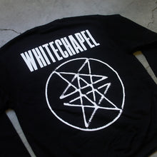 Load image into Gallery viewer, close up image of the back of a black crewneck against a grey concrete background. Across the shoulder area of the crewneck in big white letters says &quot;whitechapel&quot;. Below that is what is called a double pentagram, it is a white circle with two stars mirroring and slightly overlapping each other on the inside of the circle.
