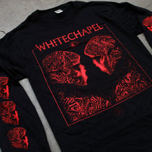 Load image into Gallery viewer, close up Image of the front of a black longsleeve on a grey concrete background. The front shows two skulls/skeletal figures from the shoulders up looking at one another- made up of red and black oil. This is outlined in a thin red square. Above the square in red text with the top line of the square going through the letters reads &quot;whitechapel&quot;. Below the word &quot;whitechapel&quot; is a red image of an opened eyeball. Both sleeves have 3 of the skeletal figure heads on them, facing inwards.
