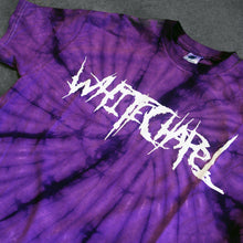 Load image into Gallery viewer, close up, angled image of a purple spider tie dye tee shirt on a cracked concrete background. tee has front center chest print across in white that says Whitechapel
