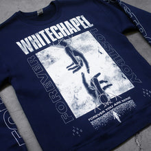 Load image into Gallery viewer, close up  Image of a black crewneck against a grey concrete background. Across the chest in white distressed text reads &quot;whitechapel&quot;. below this is a white square with two hands reaching to touch each other from the top and bottom of the swuare. The sides of the swuare in white outline text reads forever lost boy. the bottom of the square in white text says forever you are mine with a white silhouette. the left sleeve says lost boy and the right sleeve says forever, both in an outlined white text.
