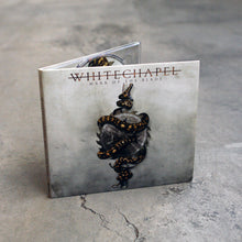 Load image into Gallery viewer, Image of a cd case against a cracked concrete background. The cd case is a white and grey gradient. The top says &quot;whitechapel&quot; with a thin line through it. below this in black text reads &quot;mark of the blade&quot;. Below this is a silver colored sawblade with three stars in the center of the sawblade. A spotted brown and yellowish snake is wrapped around it, mouth open wide. 
